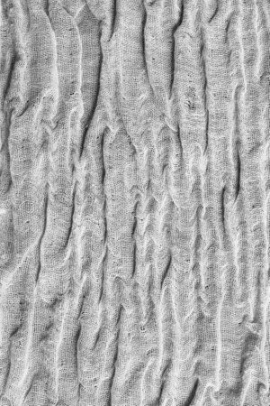 Crumpled gray fabric texture closeup as a backgroundの写真素材