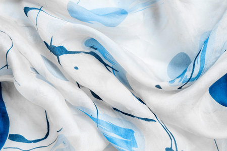 White and blue draped silk fabric closeup as a backgroundの写真素材