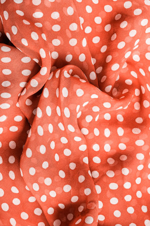 Brown draped chiffon polkadot fabric closeup as a backgroundの写真素材
