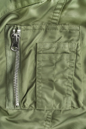 Khaki green jacket zip pocket closeup as a background