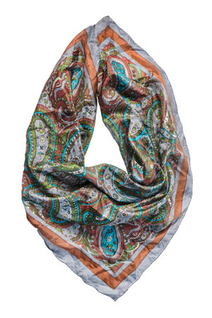 Folded vintage silk paisley print kerchief isolated over white