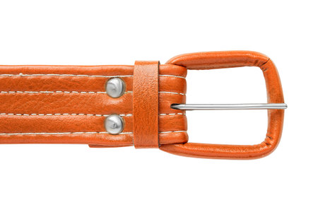 Orange color leather belt clasp buckle closeup isolated over whiteの写真素材