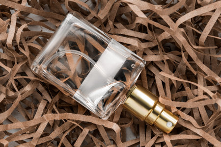Perfume spray bottle lying in brown shredded filling paperの写真素材