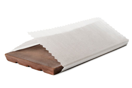 Milk chocolate wrapped in white paper isolated on white backgroundの写真素材