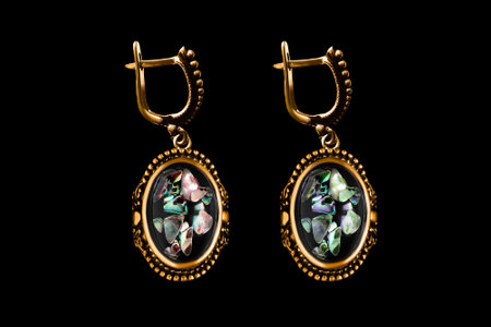 Vintage golden nacre earrings isolated on black backgroundの写真素材