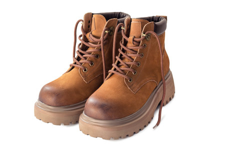 Pair of brown leather hiking boots standing isolated on white backgroundの写真素材