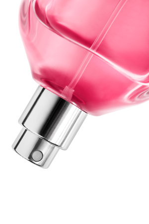 Pink perfume bottle spray closeup isolated over whiteの写真素材