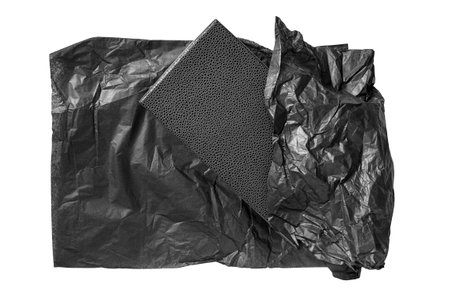 Black gift box unwrapped black packaging paper isolated on white backgroundの写真素材