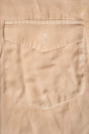 Beige cotton shirt flap patch pocket closeup as a backgroundの写真素材