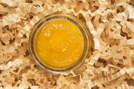 Yellow sugar lip scrub jar in yellow crinkle filling paperの写真素材