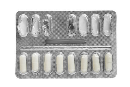 Half empty medicine pills blister isolated on white backgroundの写真素材