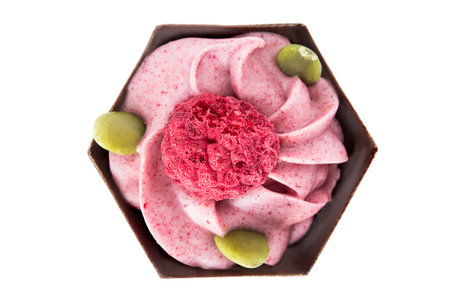 Chocolate candy with pink cream and pistachios isolated on white backgroundの写真素材