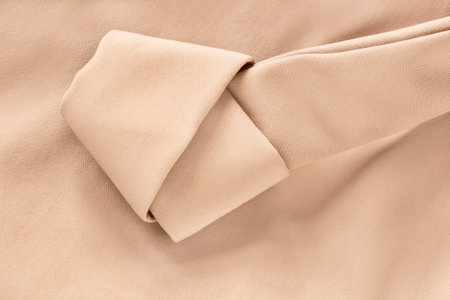 Pastel beige fabric tied knot strap clothes detail closeupの写真素材