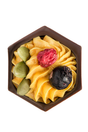 Chocolate cake with yellow cream and berries isolated on white backgroundの写真素材