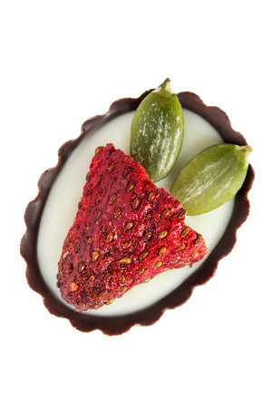 Chocolate candy with strawberry and pistachios isolated on white backgroundの写真素材