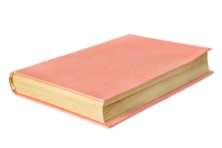 Blank pink cover old book with yellow pages lying isolated over whiteの写真素材