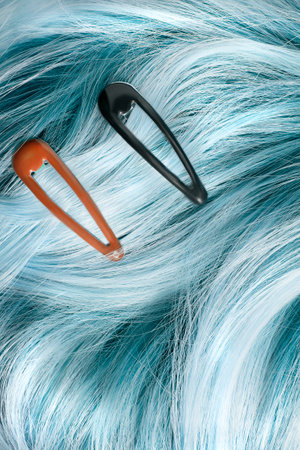 Pastel blue blonde hair with two clip barettes closeup as a backgroundの写真素材
