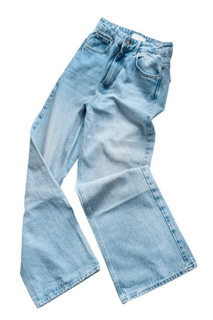 Folded light blue faded wide leg jeans isolated on white backgroundの写真素材