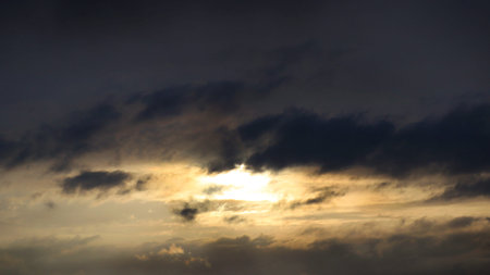 The sun came out under dark clouds as a background