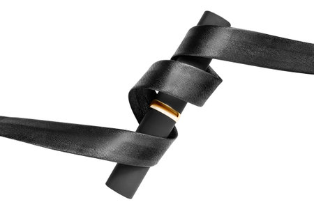Black matte lipstick case wrapped with black satin ribbon isolated over whiteの写真素材
