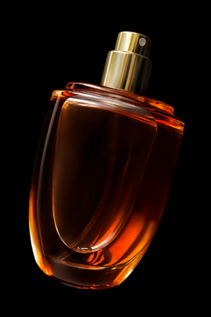 Orange color perfume glass spraying bottle isolated on black backgroundの写真素材