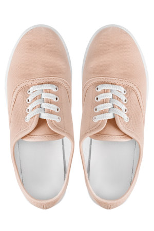 Two beige cotton sneakers isolated on white backgroundの写真素材