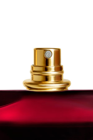 Red glass perfume spraying bottle closeup isolated over whiteの写真素材