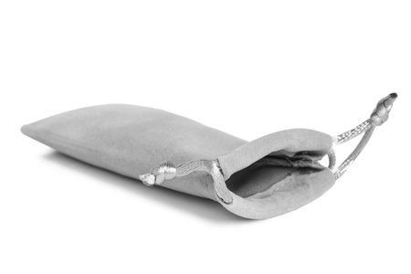 Gray velvet fabric pouch bag lying on white backgroundの写真素材