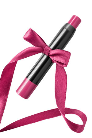 Berry pink lipstick pencil tied with silk ribbon bow isolated over whiteの写真素材