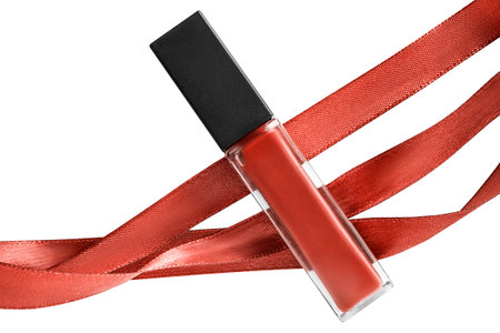 Brown liquid lipstick tube with brown silk ribbons isolated on white backgroundの写真素材