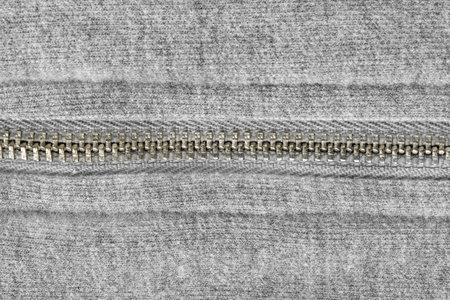 Zipped gray wool knit fabric closeup as a backgroundの写真素材