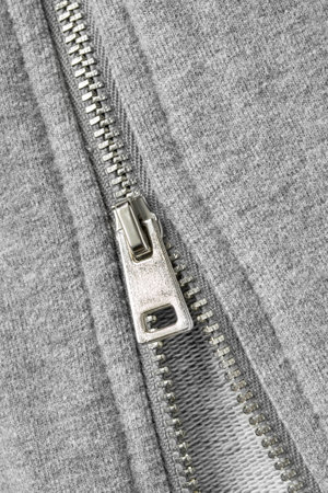 Unzipping gray knit fabric garment closeup as a backgroundの写真素材