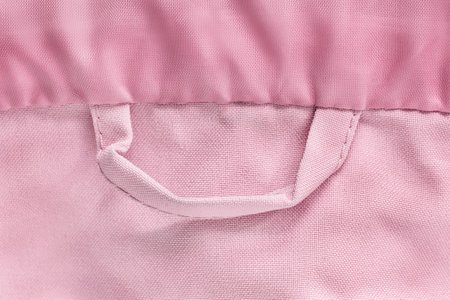 Pink fabric shirt hanger loop closeup as a backgroundの写真素材