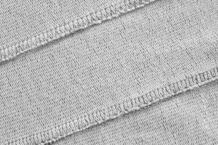 White knit fabric back side with two seams as a backgroundの写真素材