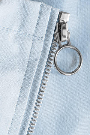 Light blue fabric metallic zip fastener closeup as a backgroundの写真素材