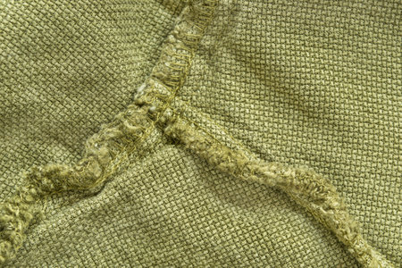 Khaki green fabric seams closeup as a backgroundの写真素材