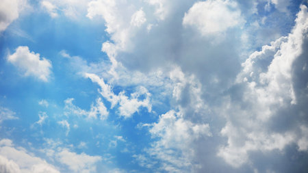 Abstract beautiful white fluffy clouds in blue skyの写真素材