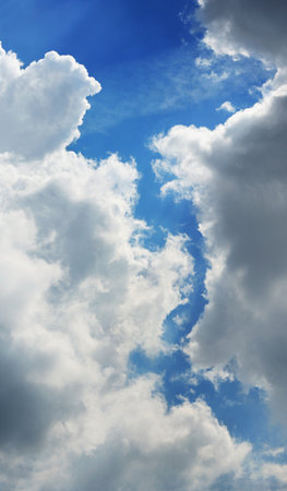 Abstract beautiful white fluffy clouds in blue skyの写真素材