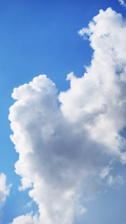 Details of white fluffy cloud in blue skyの写真素材