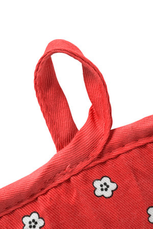 Red fabric pot holder hanging loop closeup isolated over whiteの写真素材