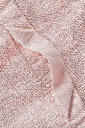Pastel pink terry towel hanging loop closeup as a backgroundの写真素材