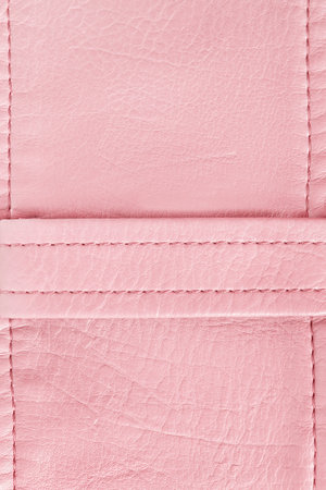Pink leather stitched blank patch closeup as a backgroundの写真素材