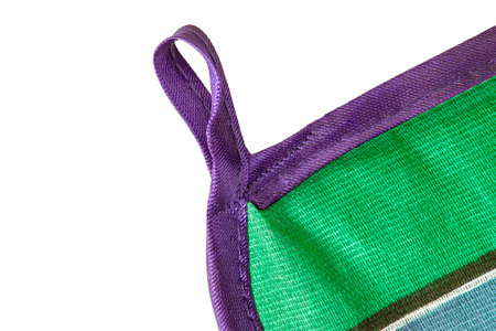 Handmade fabric pot holder hanging loop closeup isolated over whiteの写真素材