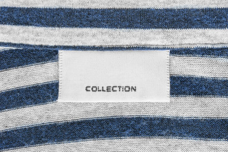 Clothes label text collection on striped knit fabric backgroundの写真素材