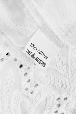 Fabric composition and washing instructions clothes label on white fabric backgroundの写真素材
