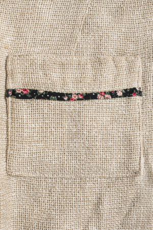 Beige canvas fabric jacket patch pocket closeup as a backgroundの写真素材