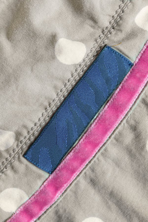 Black patch label over gray cotton fabric backgroundの写真素材