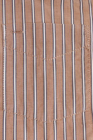 Striped beige cotton shirt patch pocket closeup as a backgroundの写真素材