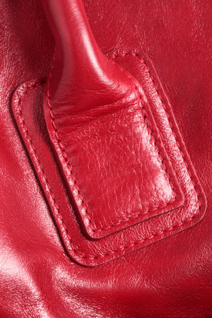 Red leather stitched bag detail closeup as a backgroundの写真素材