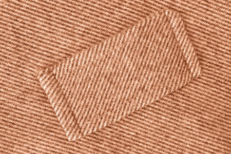 Beige wool fabric stitched patch closeup as a background